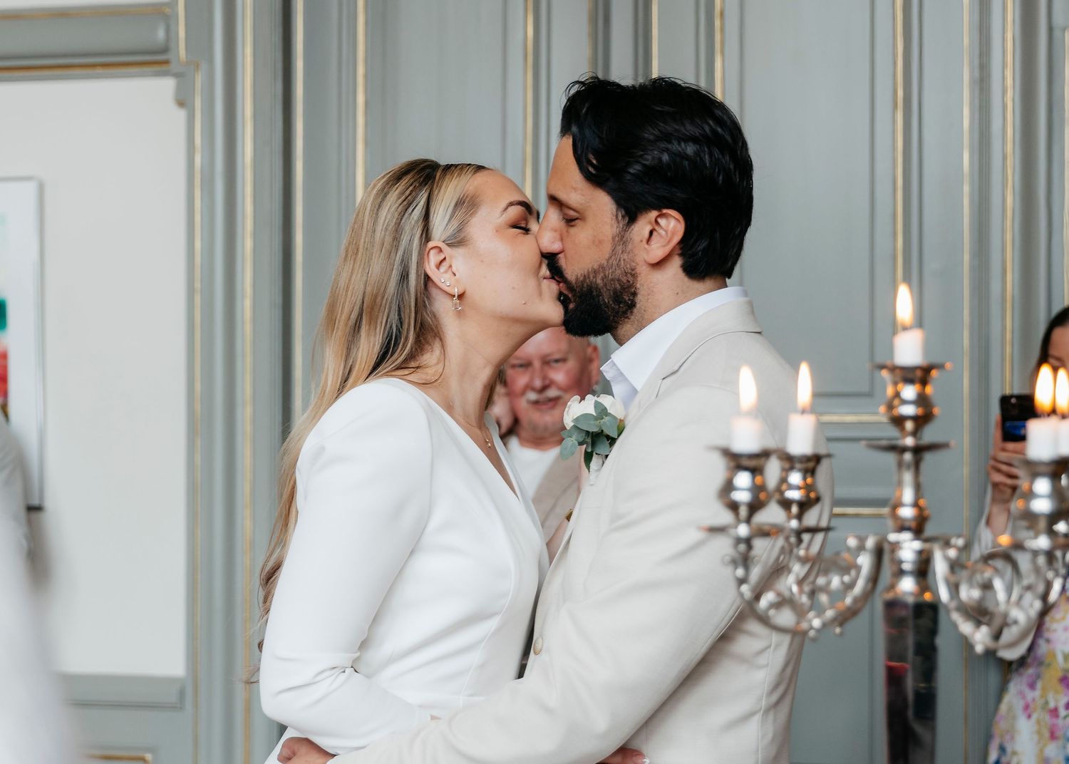 Romantic wedding ceremony moment in an elegant room with candelabras.