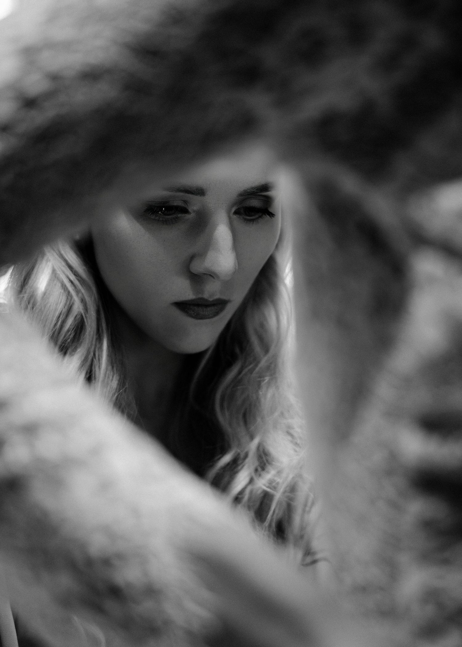 Artistic black and white portrait series with dramatic lighting and shadows.