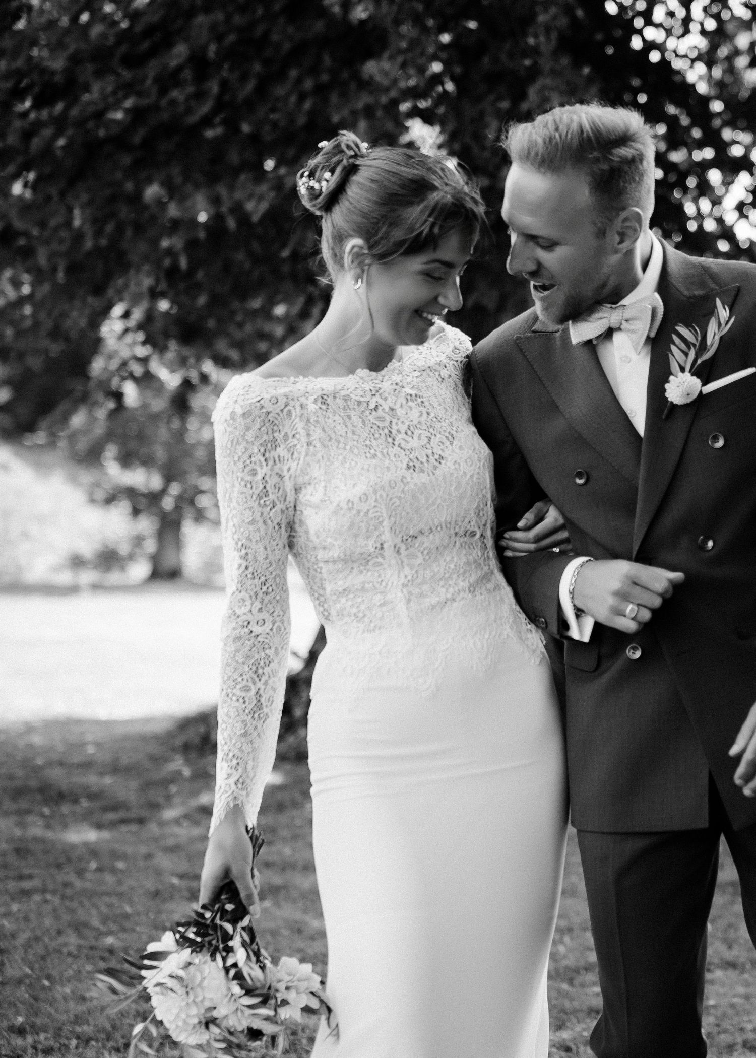 A romantic wedding couple embraces in a series of intimate poses wearing traditional wedding attire.