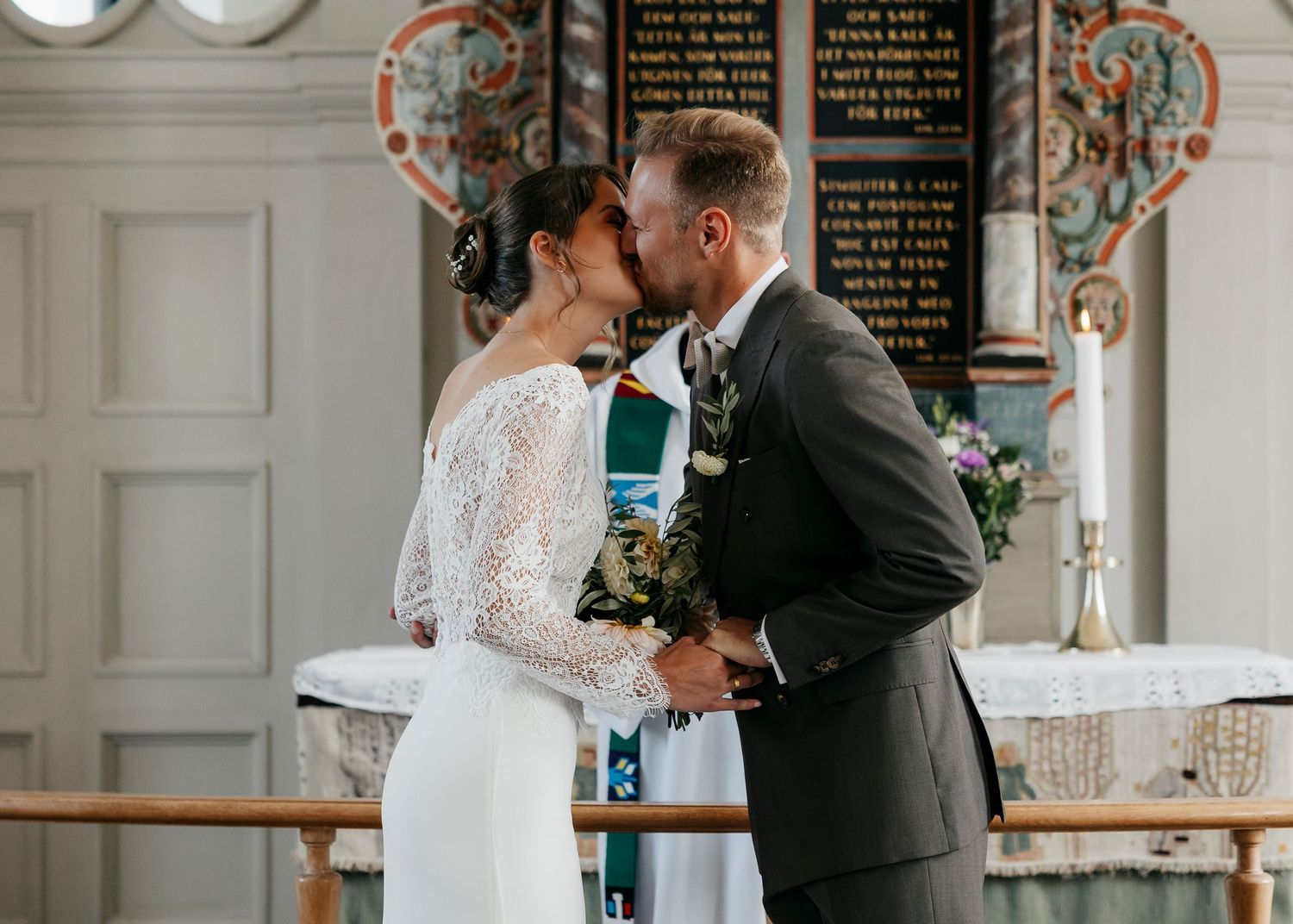 Wedding ceremony proceedings in bright church interior with traditional architecture.