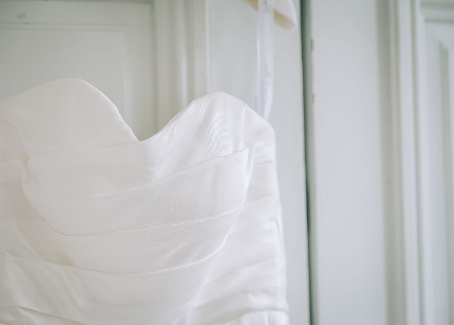 Close up detail of white wedding dress bodice with sweetheart neckline.