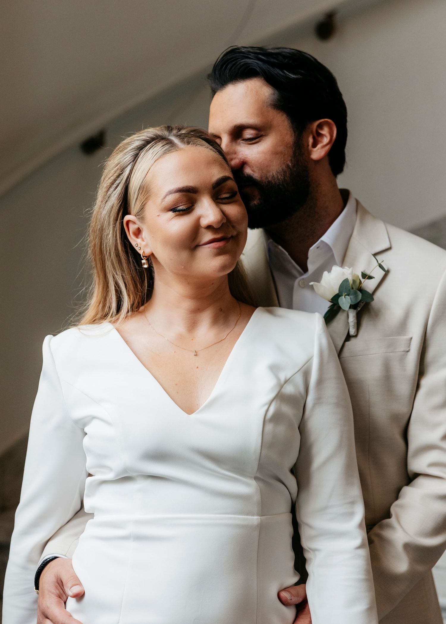 Intimate wedding portraits of a couple in white and cream attire sharing tender moments.
