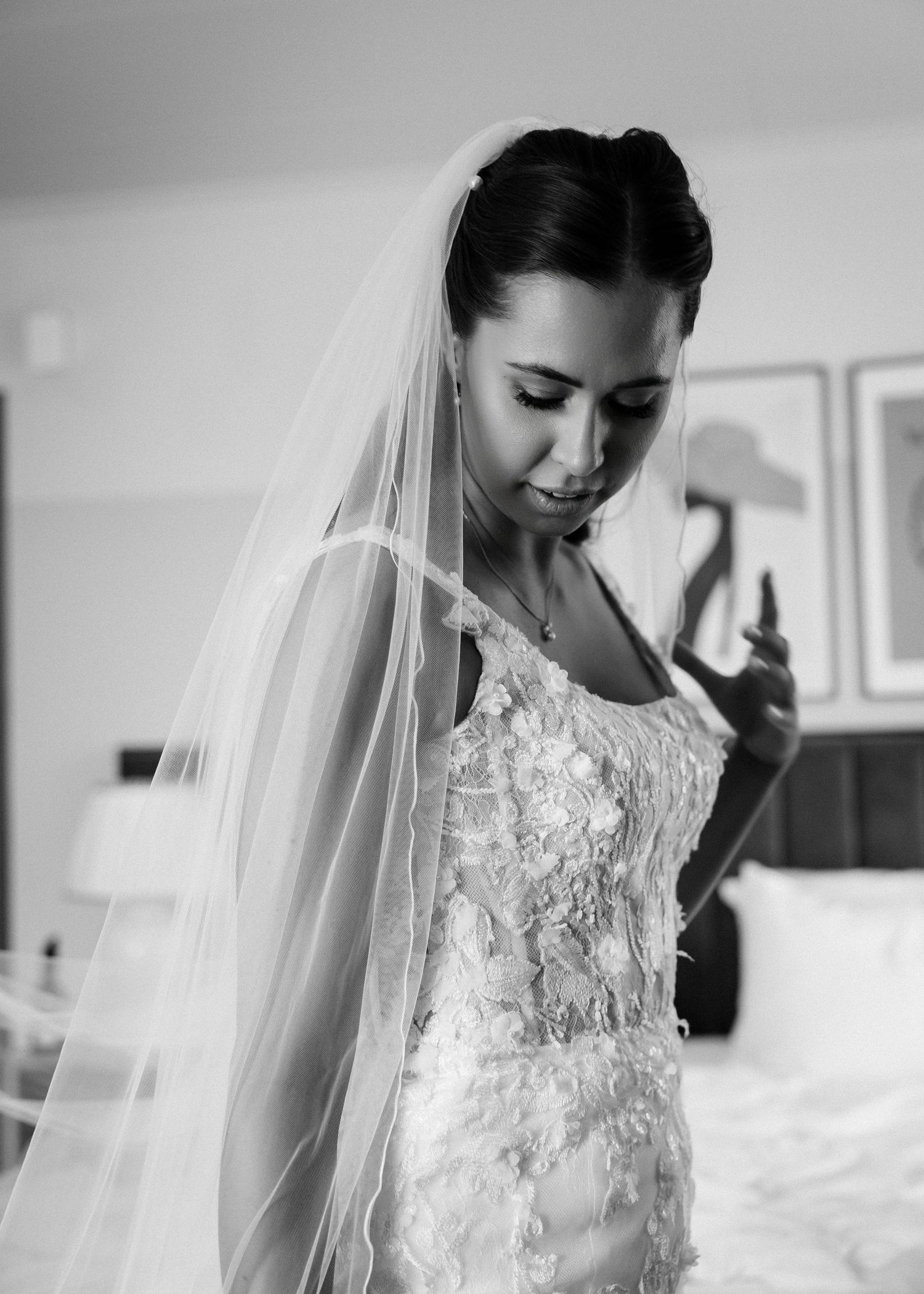 Close-up details of a delicate lace wedding dress with floral appliques and sheer elements.