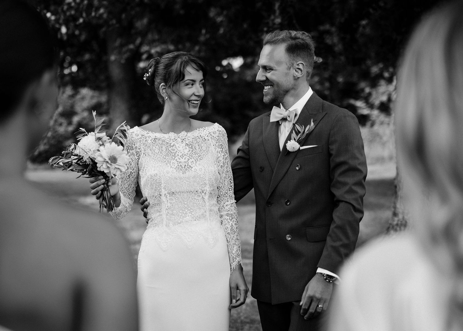 Black and white wedding portraits showing joyful moments between the couple.