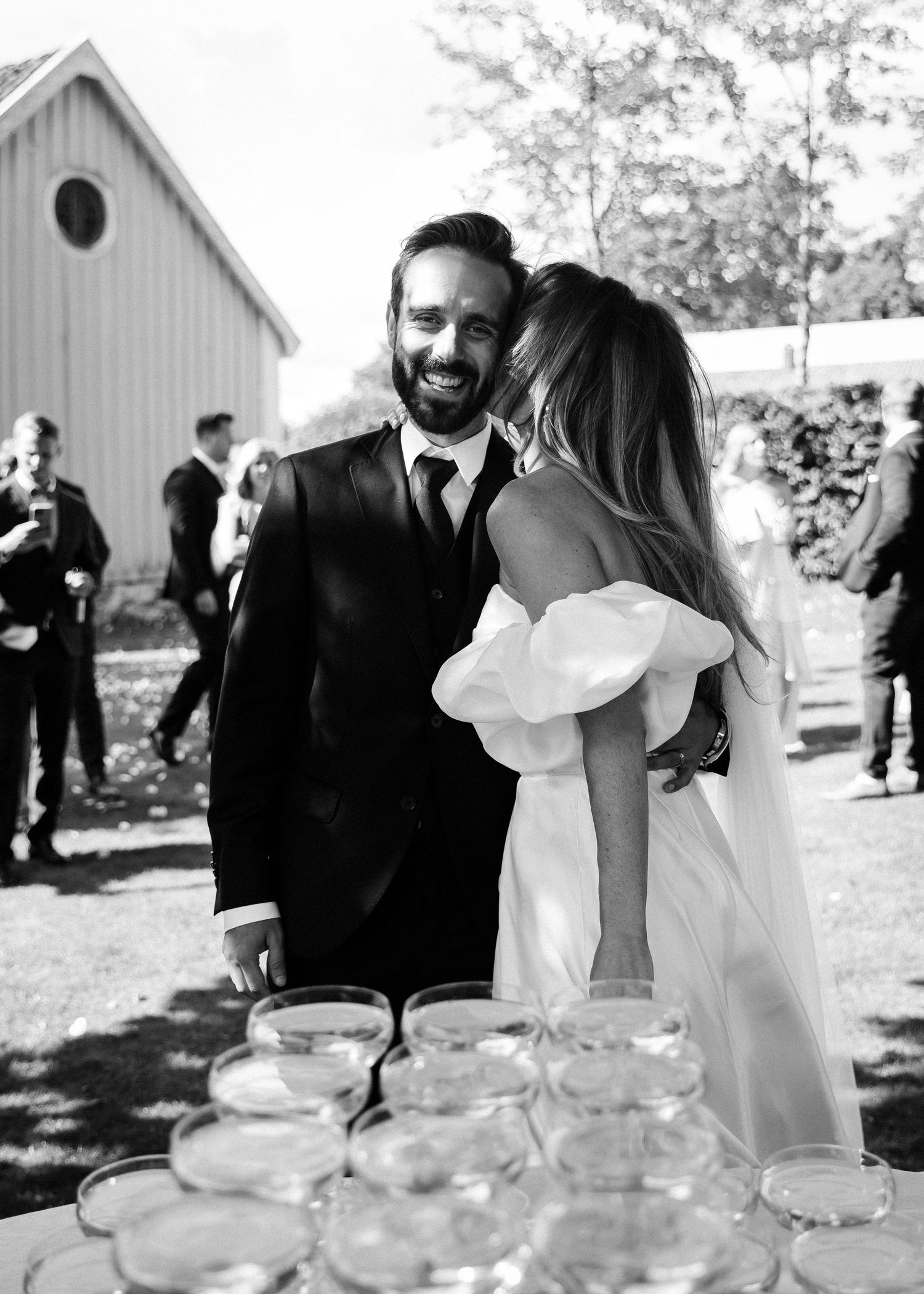 Black and white wedding reception photos showing champagne glasses and intimate moments.