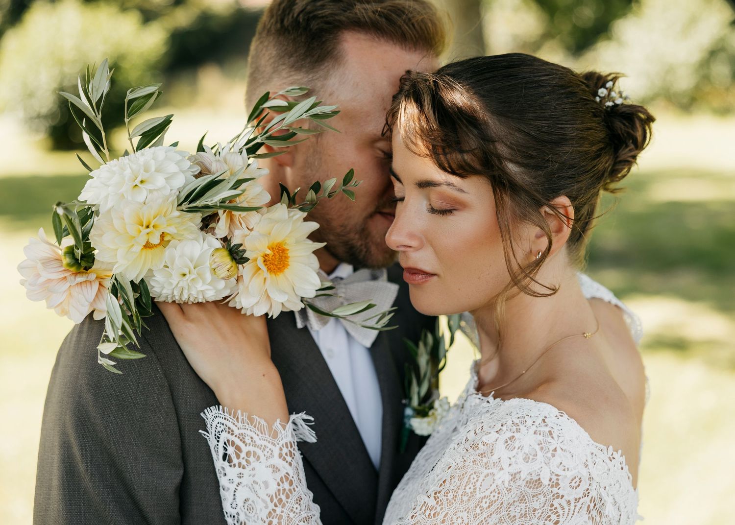 Romantic wedding portraits featuring lace dress details and natural outdoor lighting.
