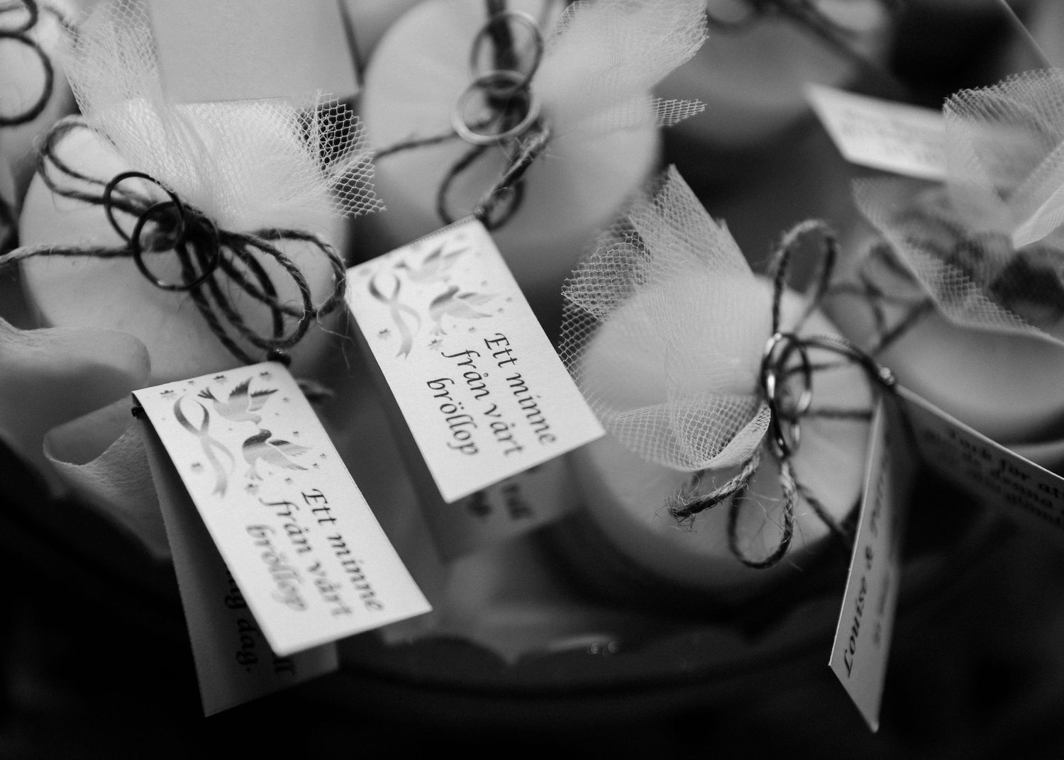Close-up black and white detail shots of handwritten gift tags and ribbons.