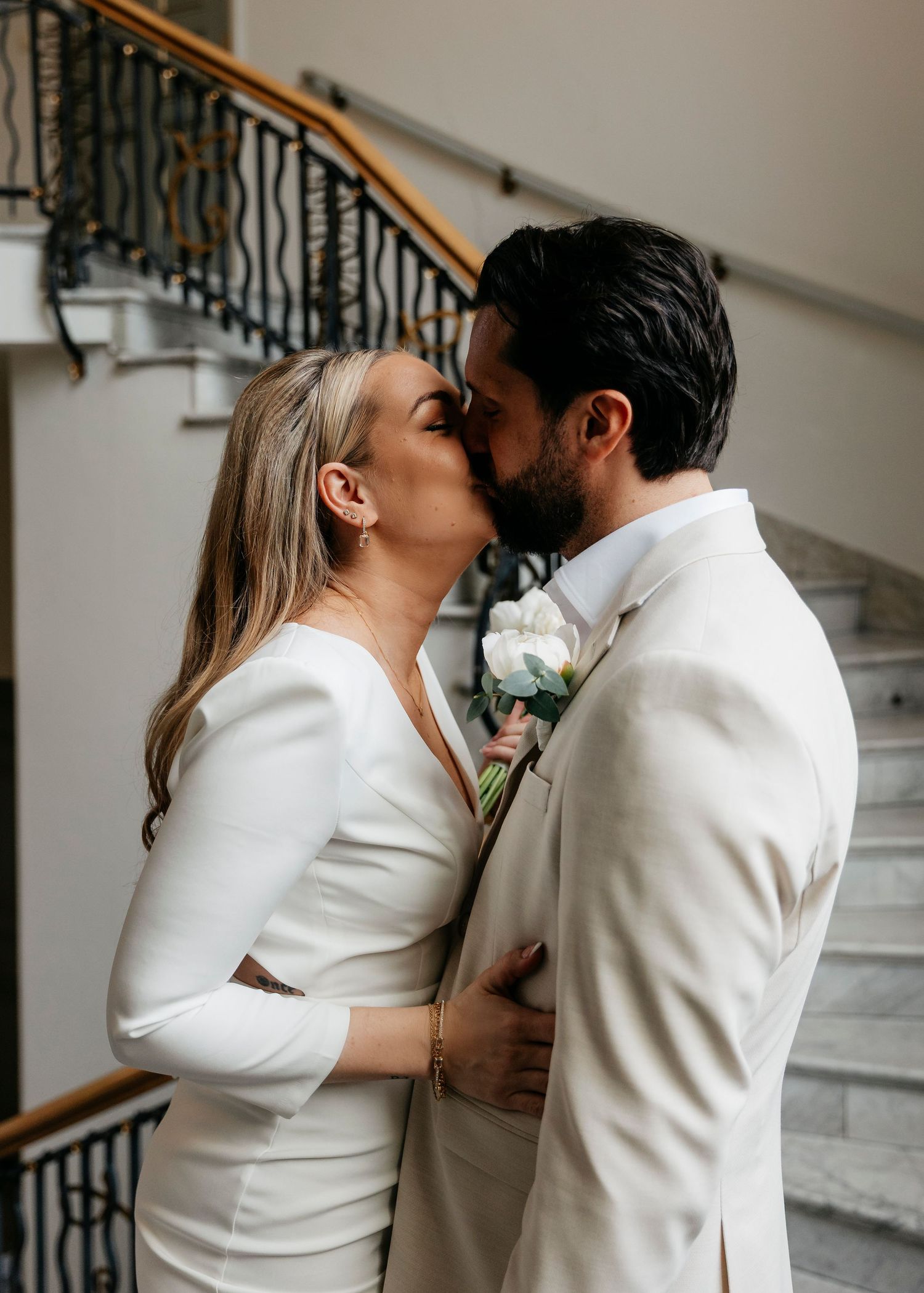 A series of intimate wedding photos capturing a couple's tender moments on a staircase.