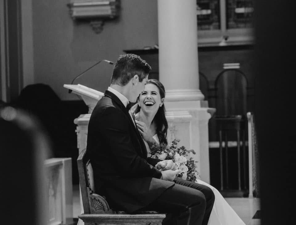 Black and white wedding ceremony moment captured in an elegant indoor venue.