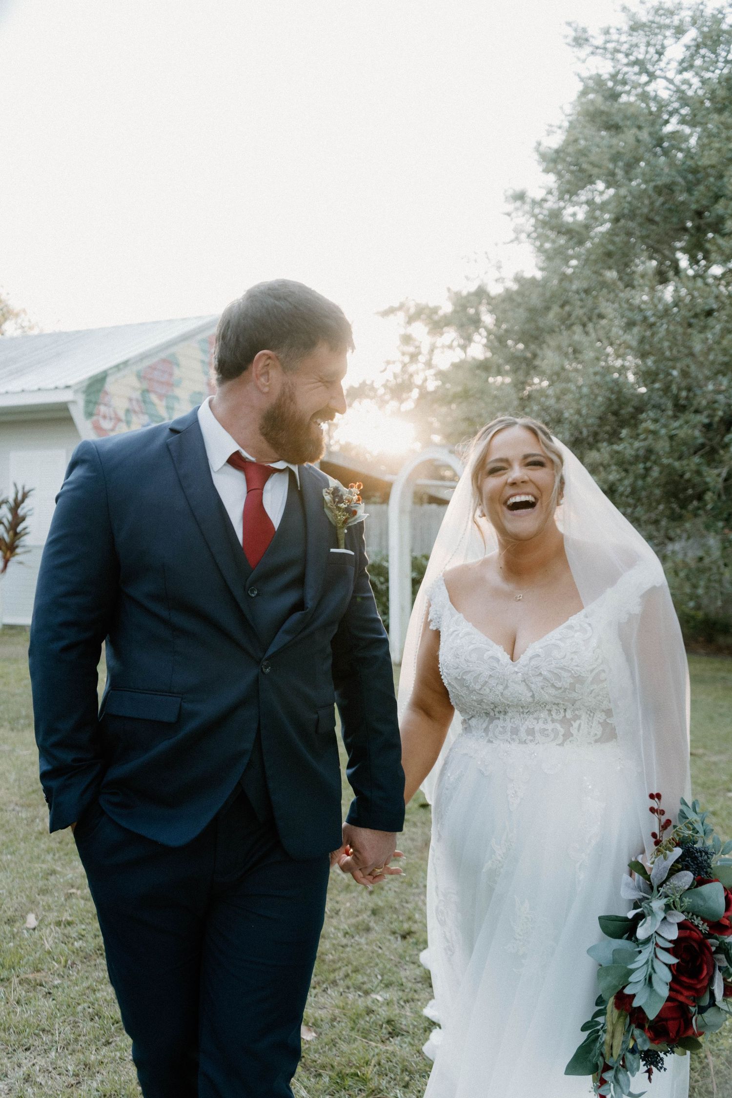 Wedding couple shares intimate moments in an outdoor garden setting at sunset.