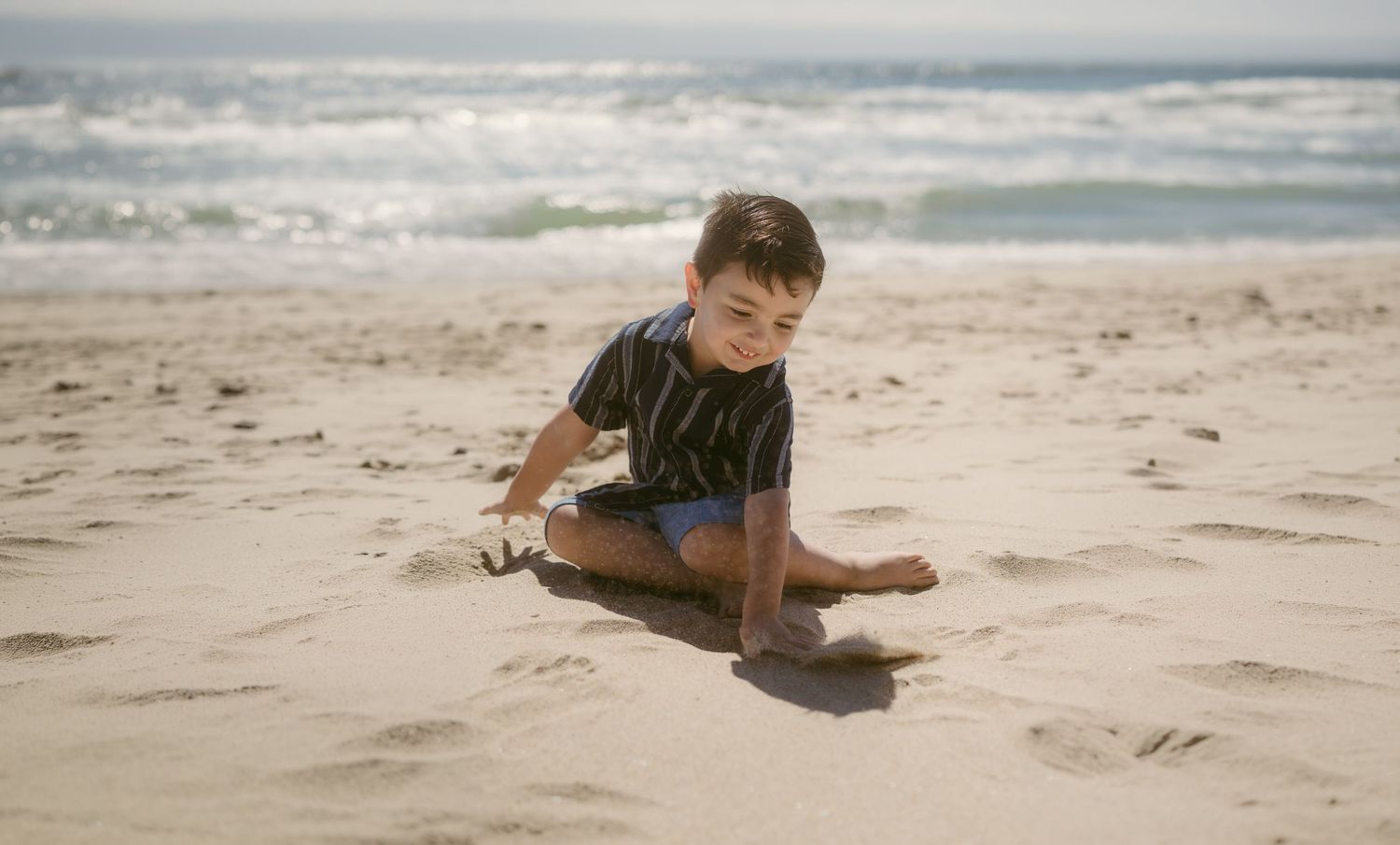 kid playing in sand