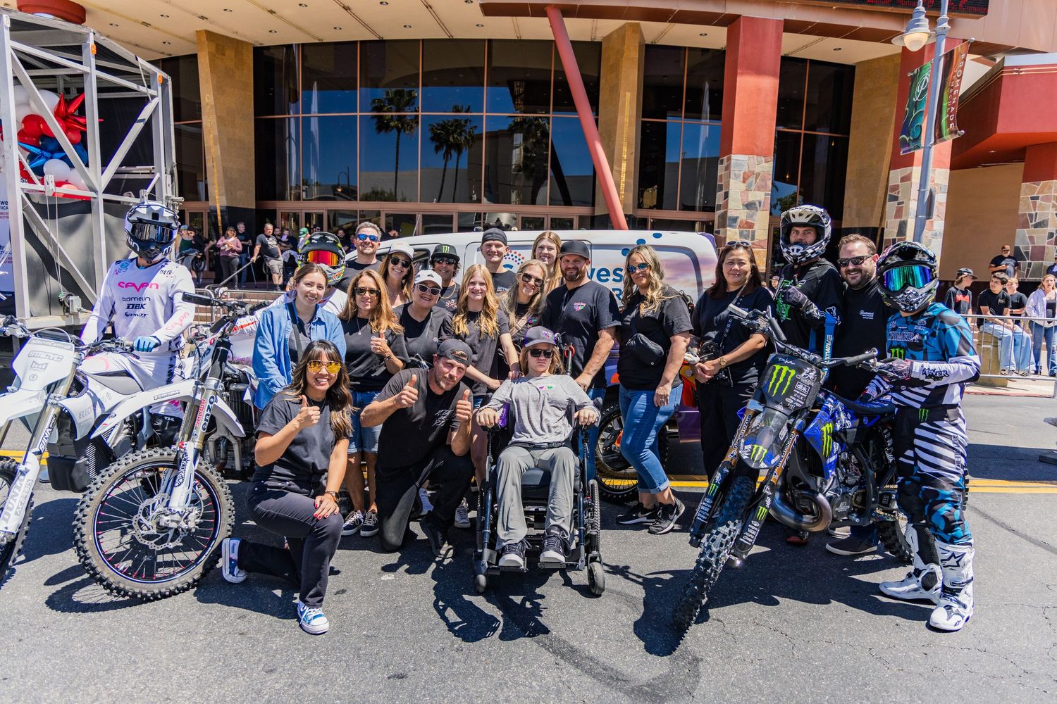 Large group of spectators gathered at an urban motorcycle event.