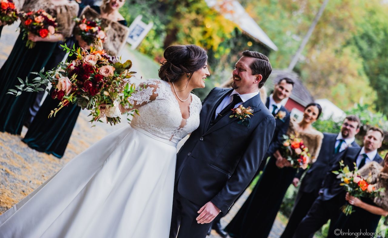Wedding ceremony moments with fall colors and floral decorations in outdoor setting.