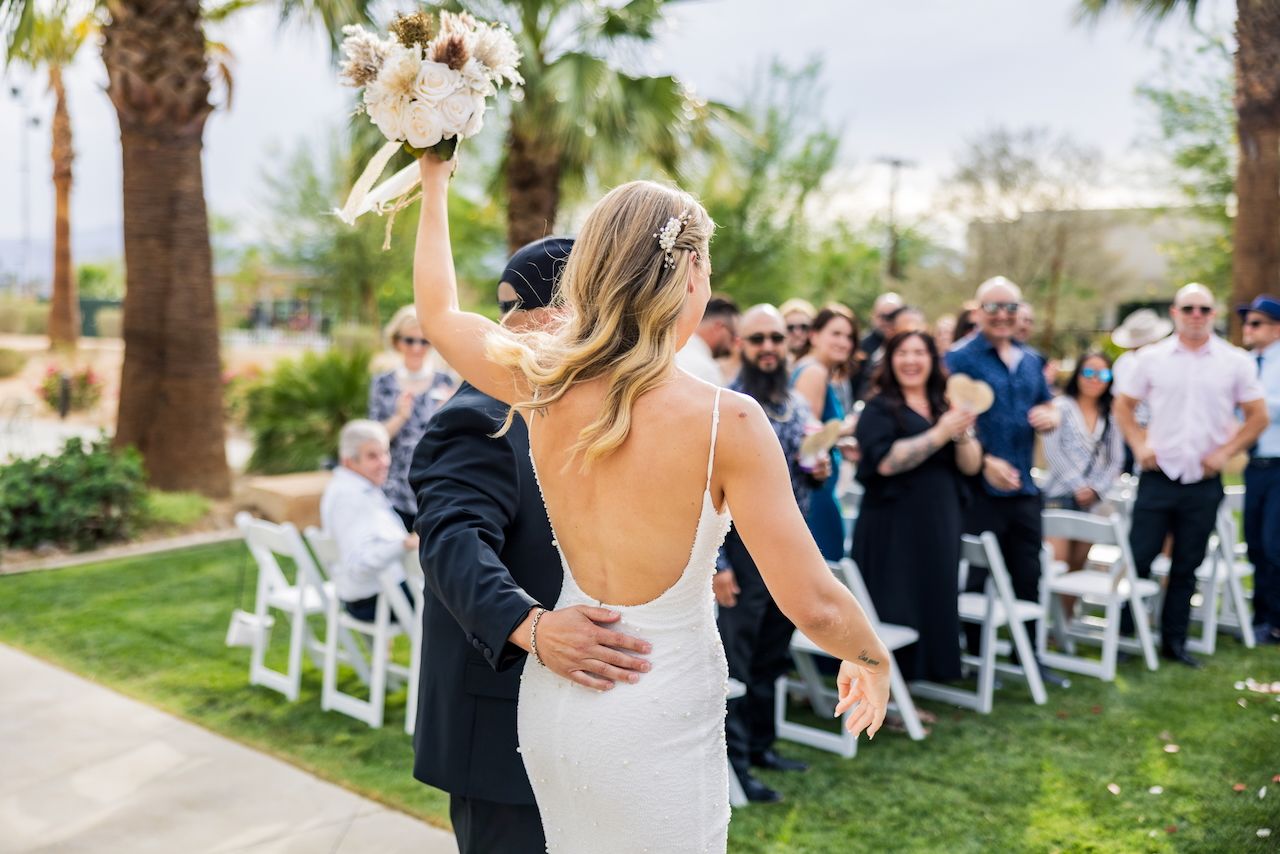 Wedding ceremony moments showing emotional embraces at an outdoor venue with palm trees.