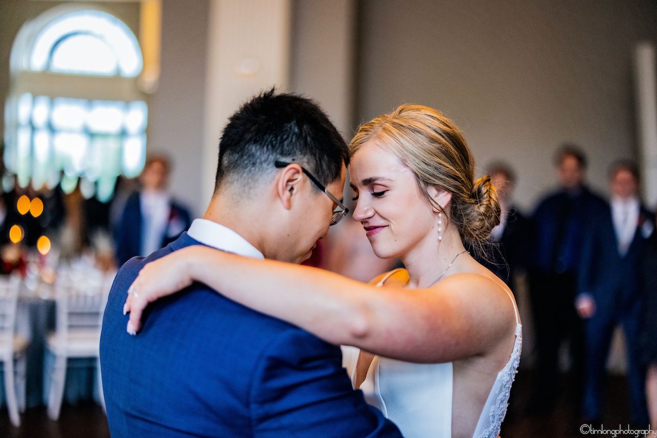 Couples dancing together at an elegant wedding reception.