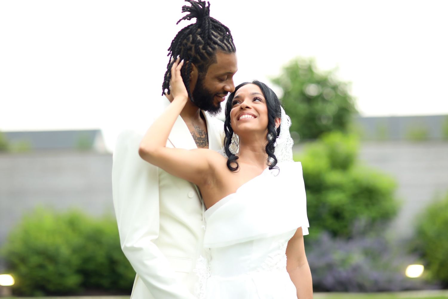Elegant outdoor wedding ceremony with white floral arrangements.