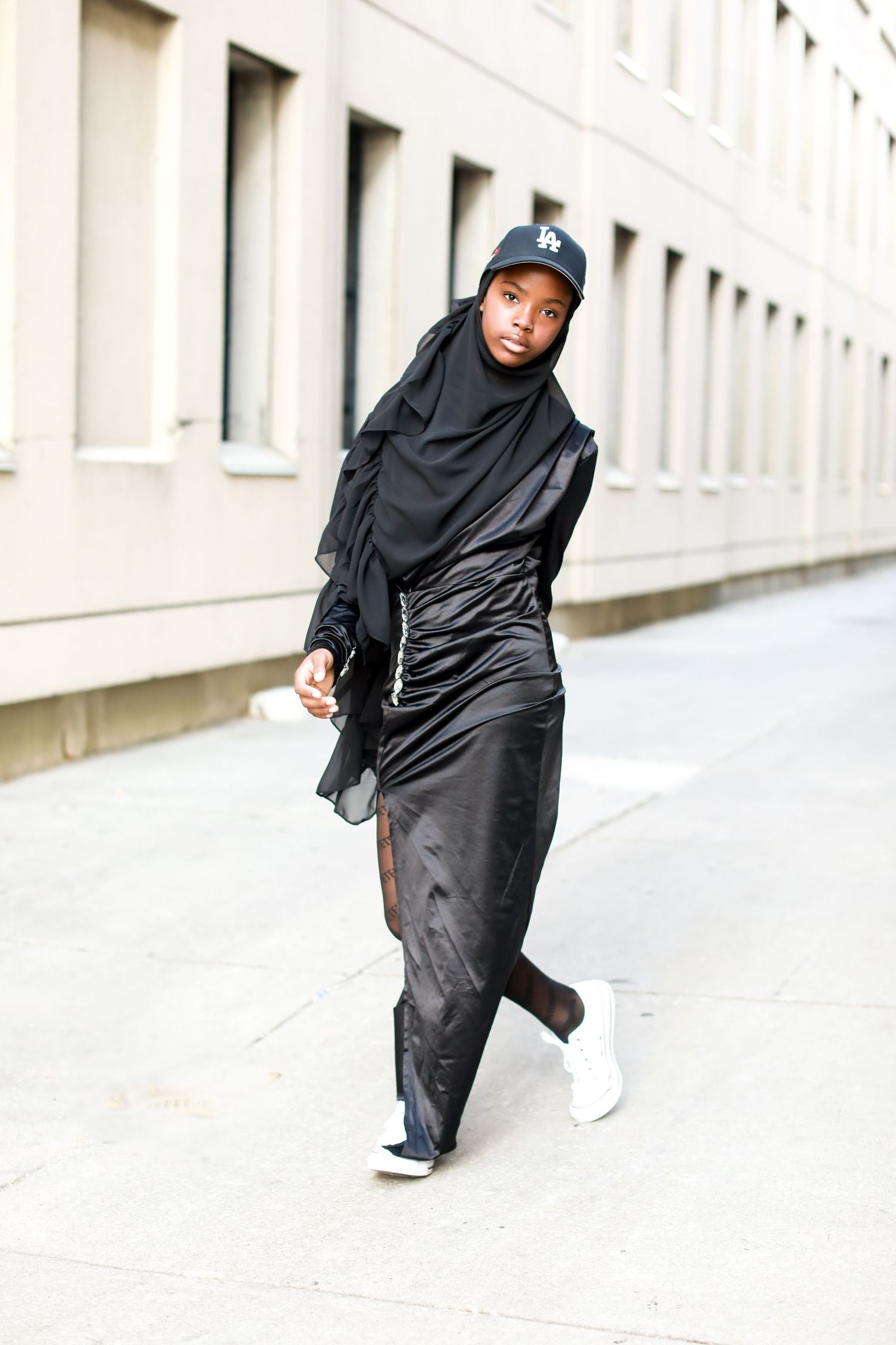 Fashion photography series featuring flowing black garments against an urban concrete backdrop.