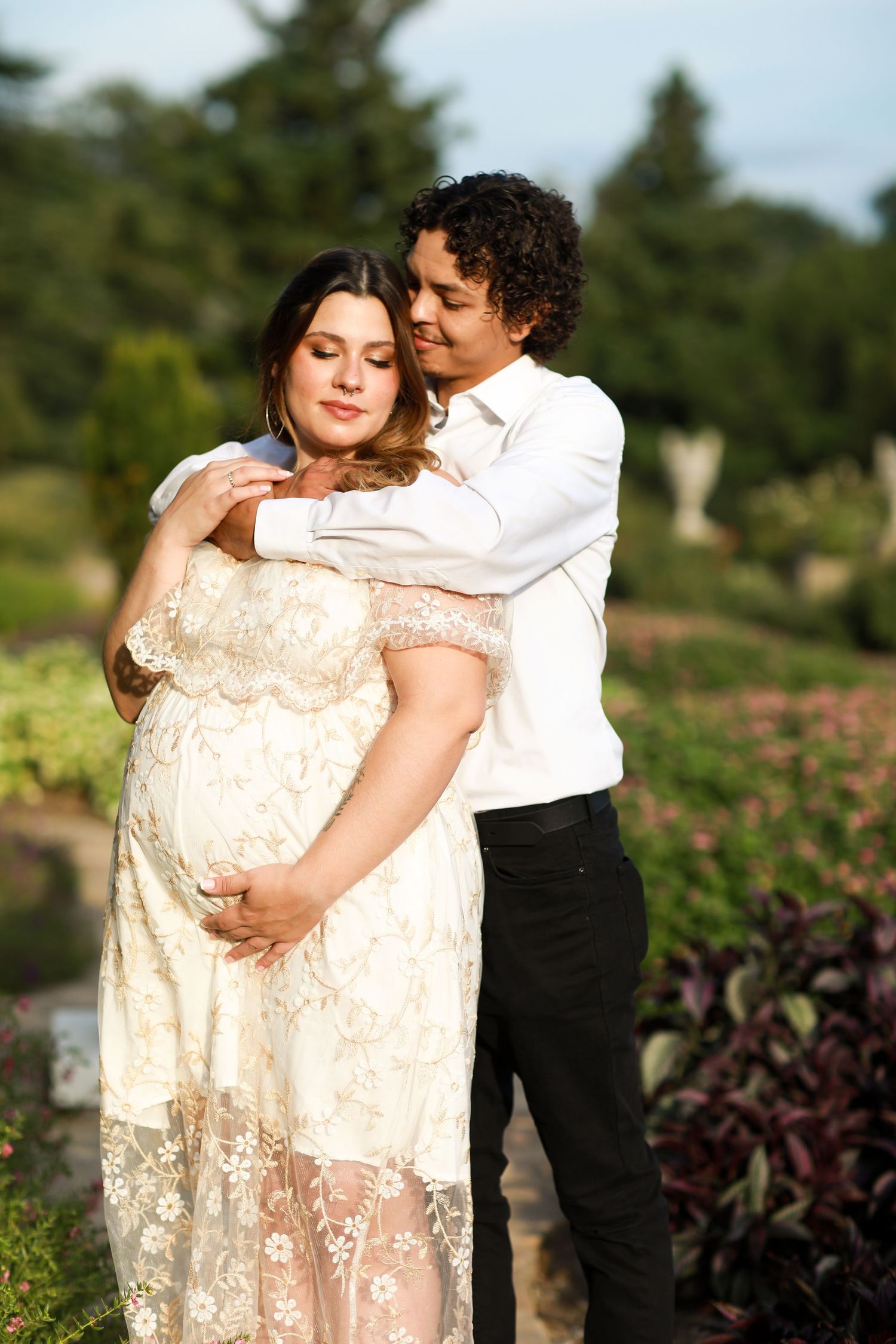 Romantic couple photos in garden setting with lace dress and formal attire.