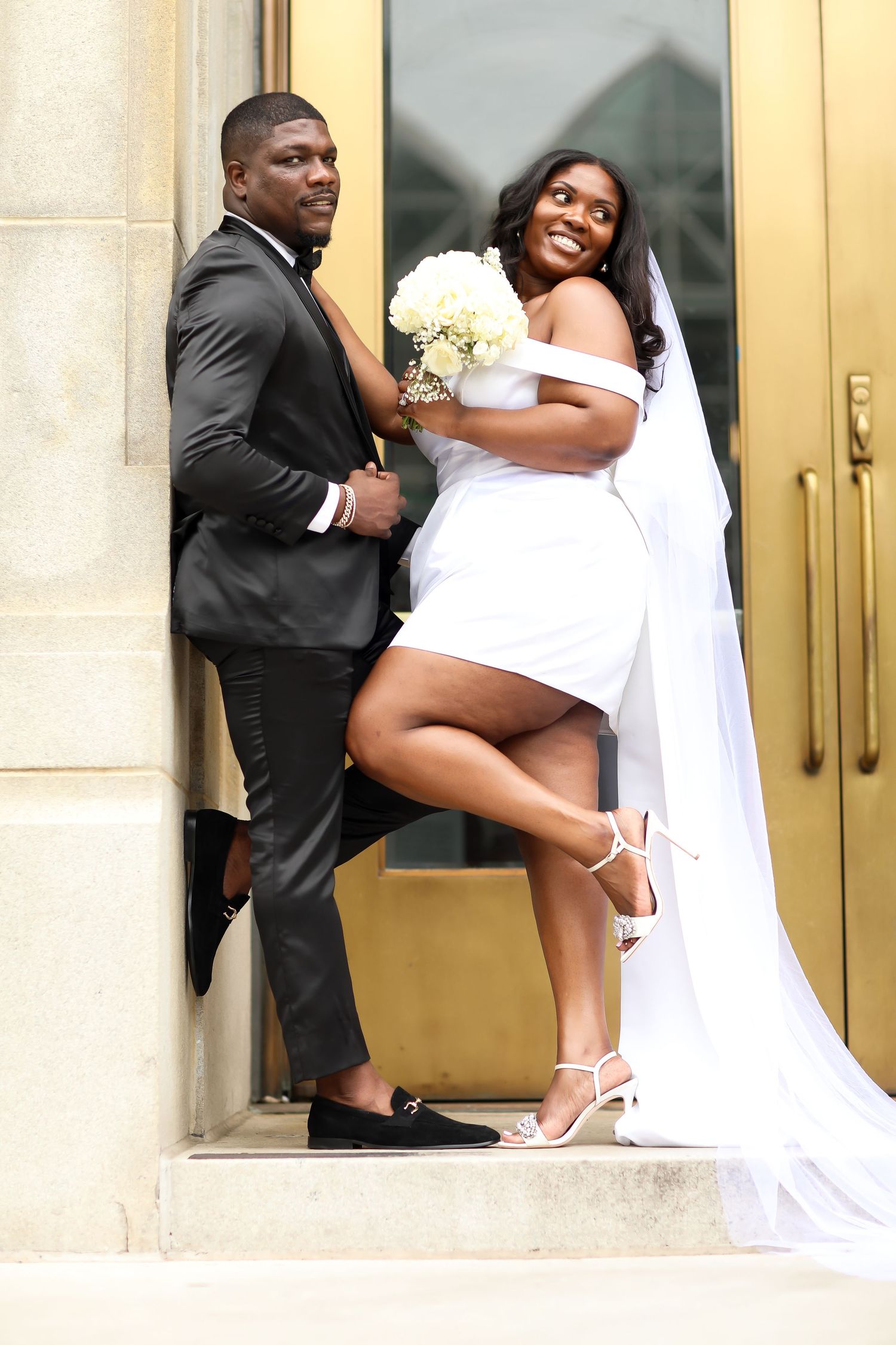 A playful wedding photoshoot sequence showing the couple posing by golden doors.