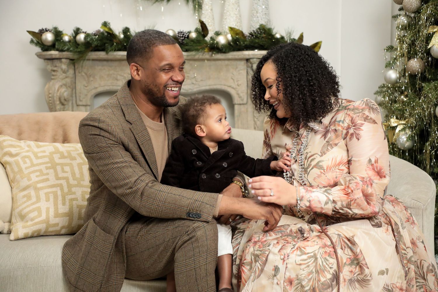Family sharing intimate moments on cream colored couch in stylish living room.