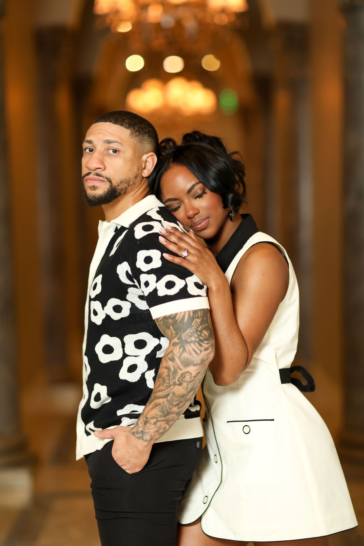 A couple shares intimate dance moments in an elegantly lit indoor venue.