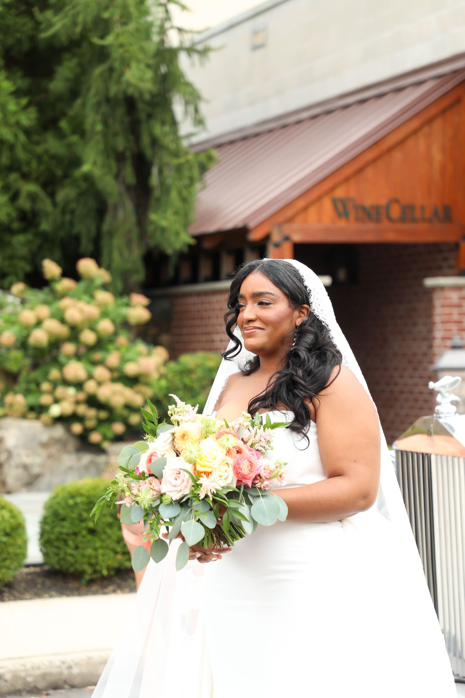 Beautiful bridal portrait with yellow roses and greenery in background.
