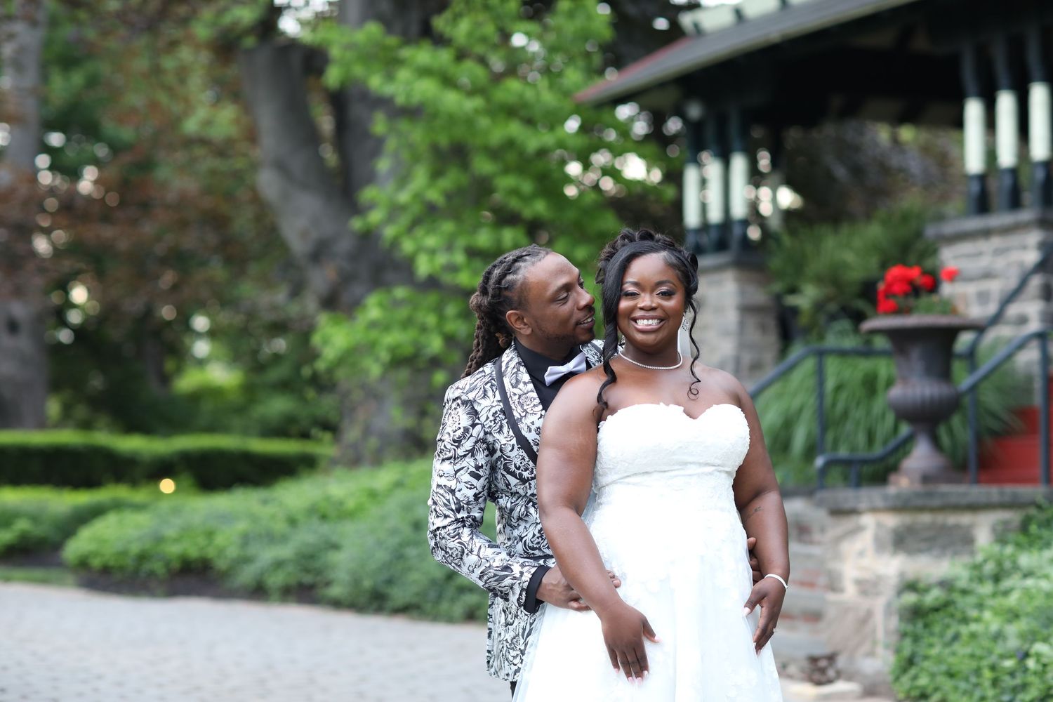 Romantic outdoor wedding photos taken in a lush garden setting.