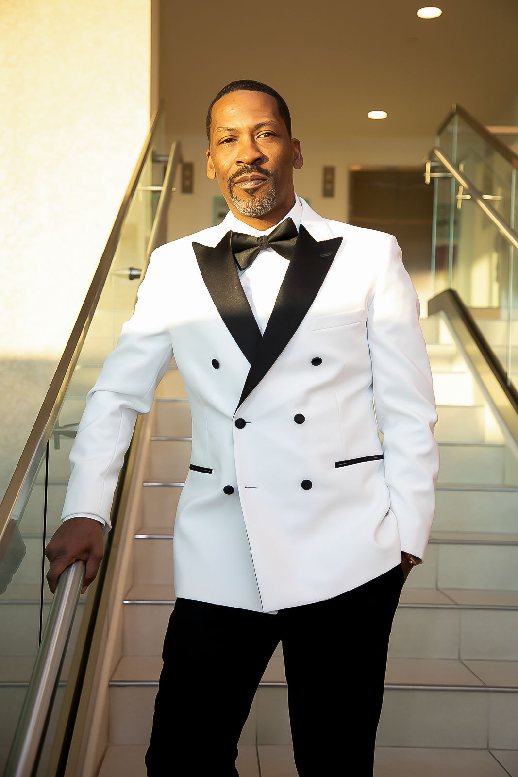 Stylish white tuxedo jacket with black lapels and buttons shown in multiple detail shots.