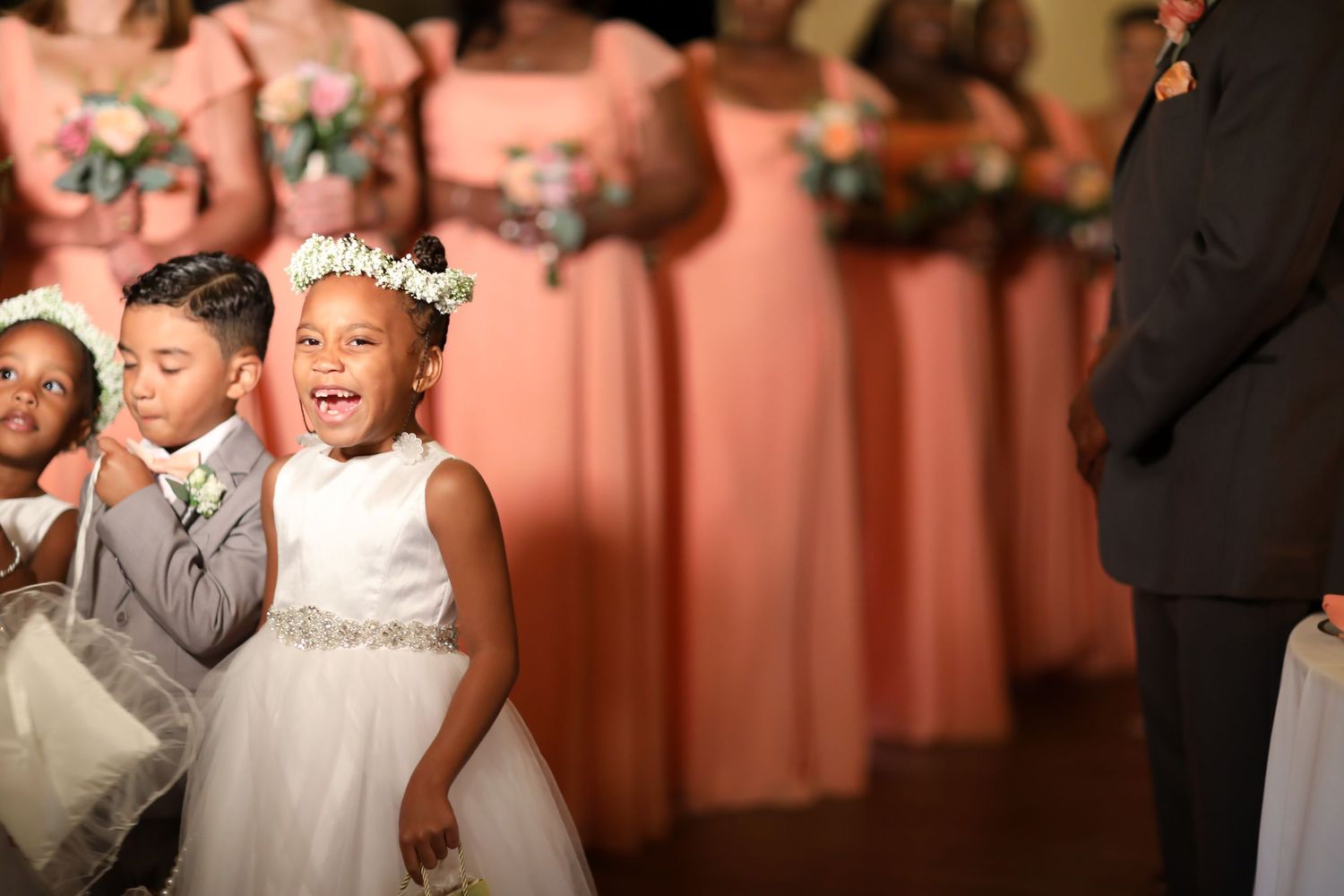 Wedding celebration with coral colored decor and formal attire.