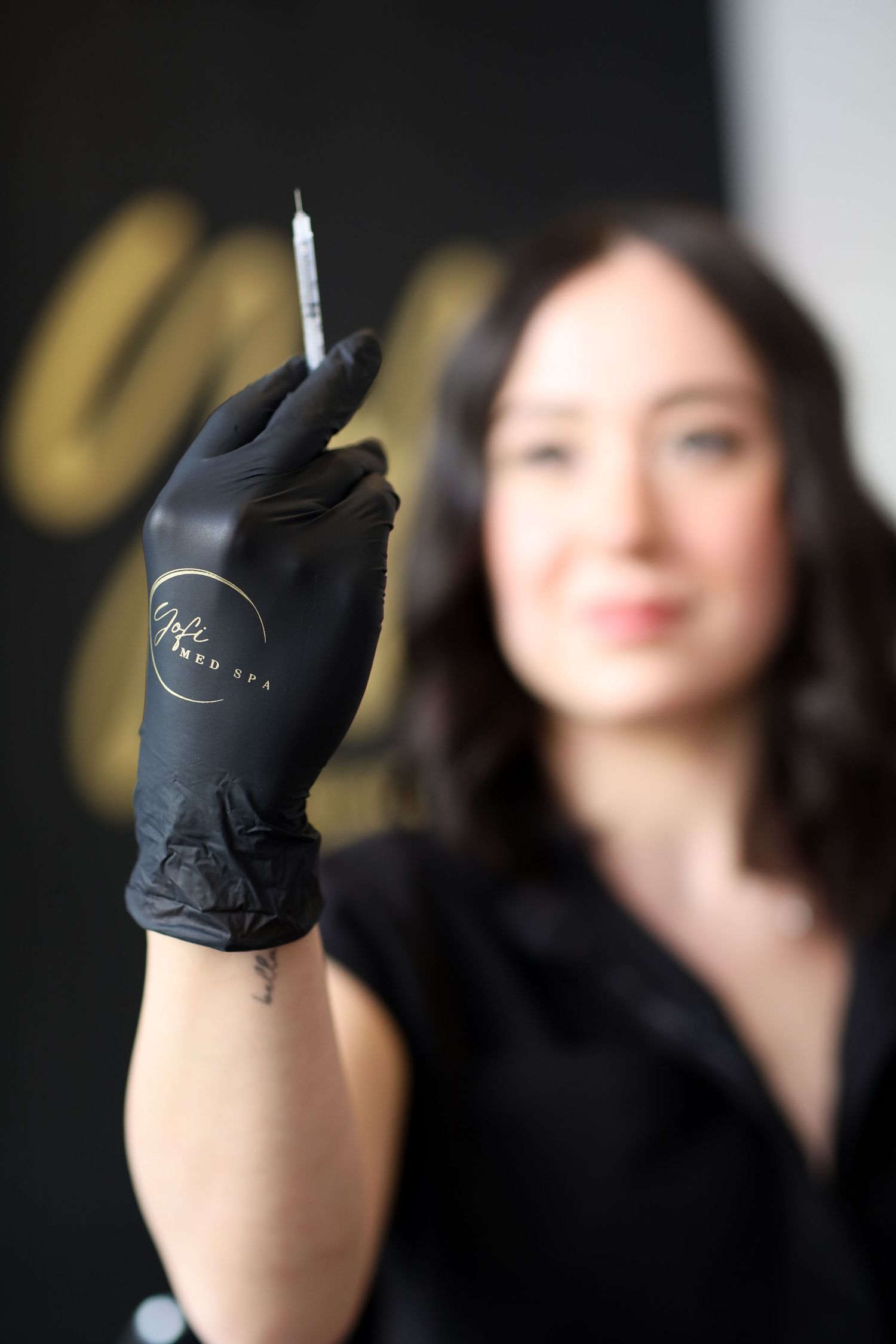 Five close-up shots of a hand wearing a black glove pointing upward against a dark background.
