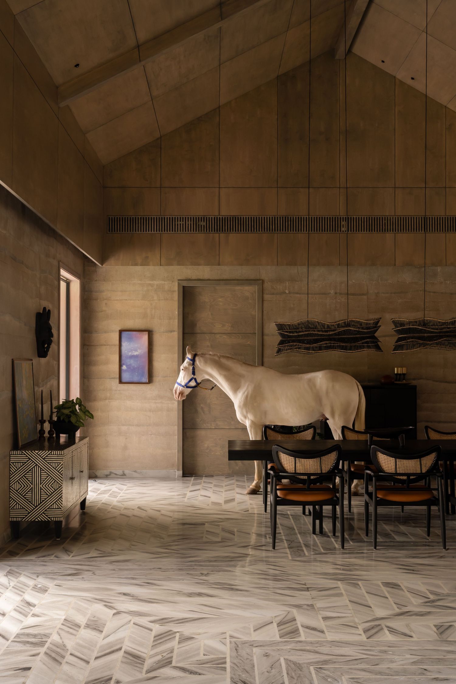 White horse standing in rustic stone interior with vaulted ceiling and marble floors.