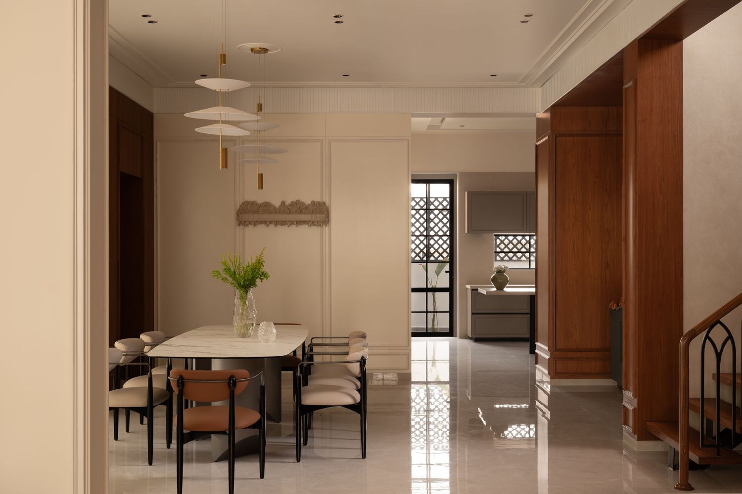 Contemporary dining room with marble table, mixed chairs, pendant lights, and glossy tile flooring.