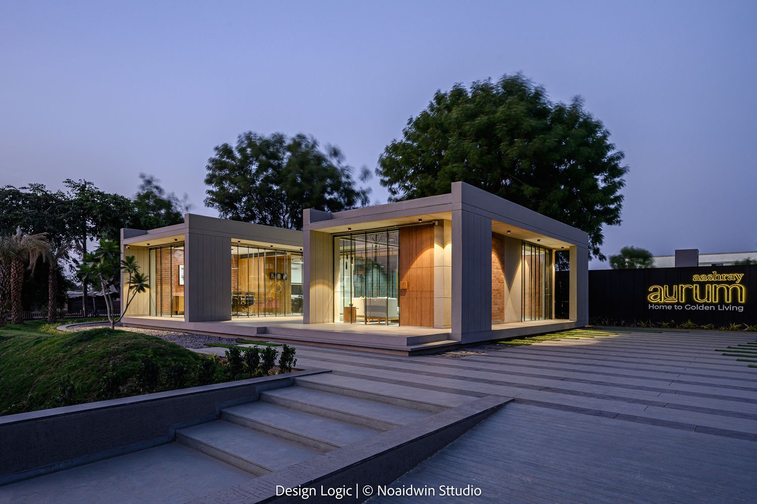 Contemporary architectural pavilion with cantilevered flat roof, glass walls, wooden details, and illuminated interior at dusk.