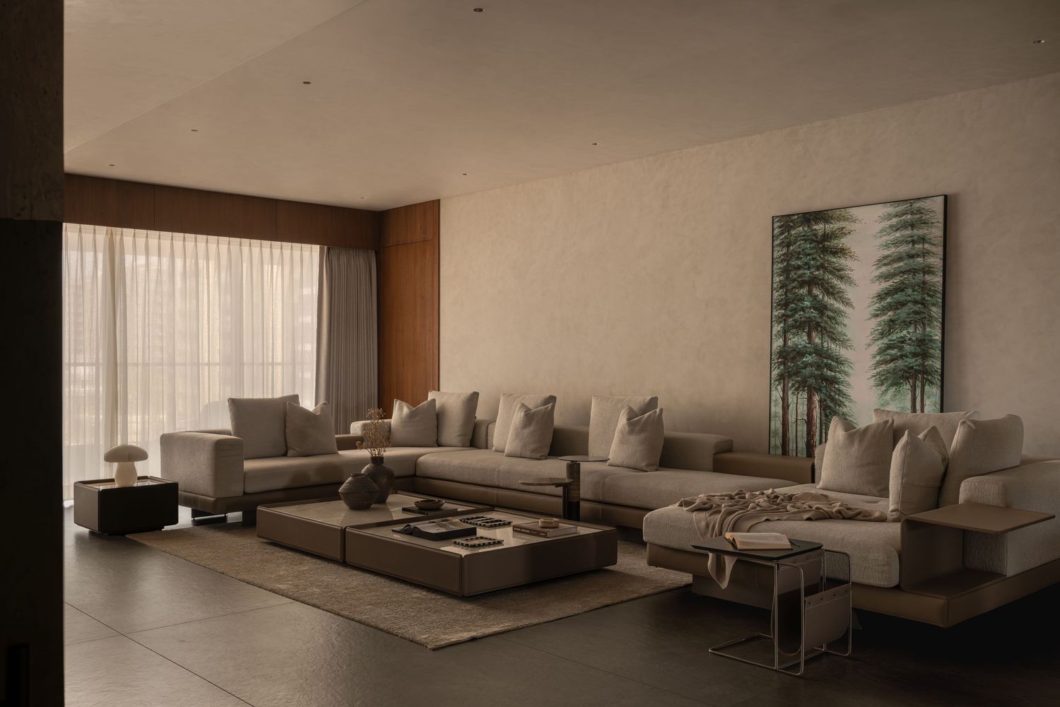 Modern living room with large L-shaped gray sofa, low coffee table, and tropical wall art in neutral tones.