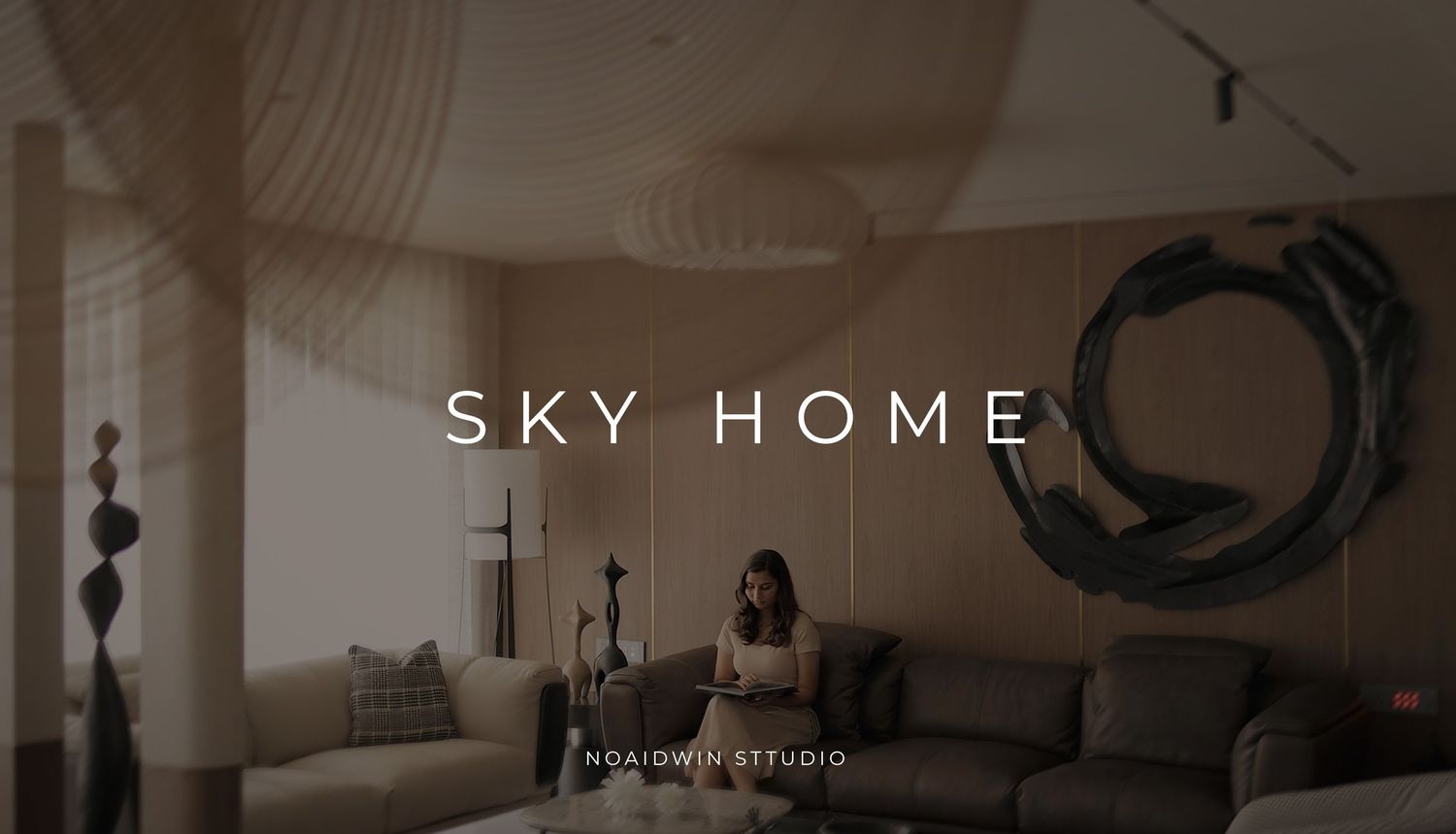 A woman sits on a sofa in a modern living room with the text Sky Home and Noaidwin Studio overlaid.