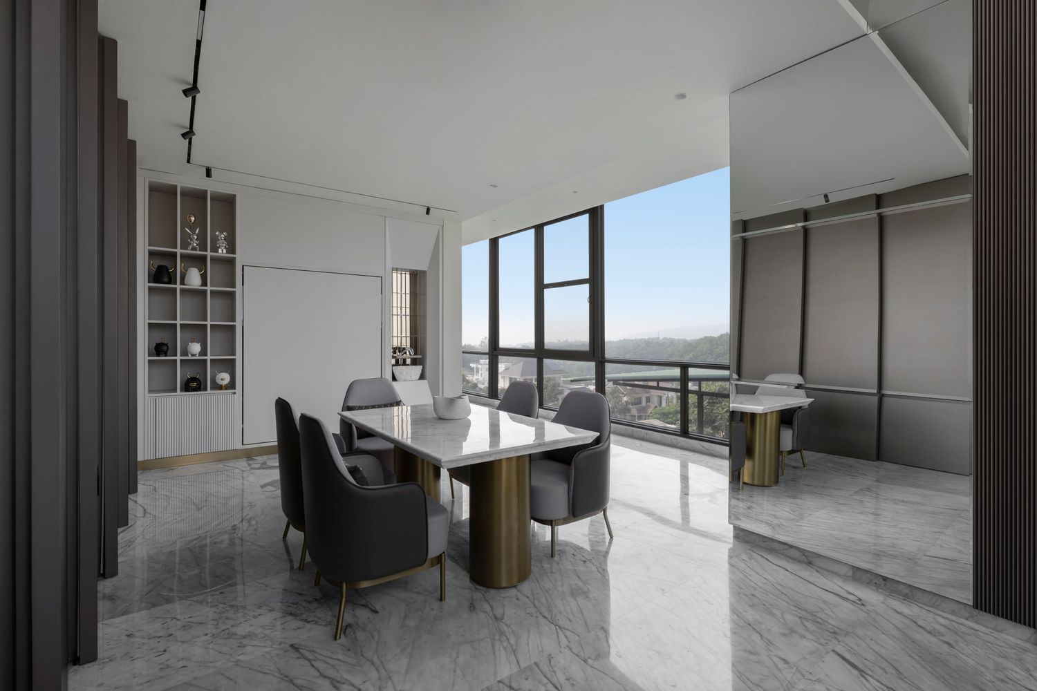 Modern dining room with marble floors, gray chairs, gold-legged table, floor-to-ceiling windows, and city views.