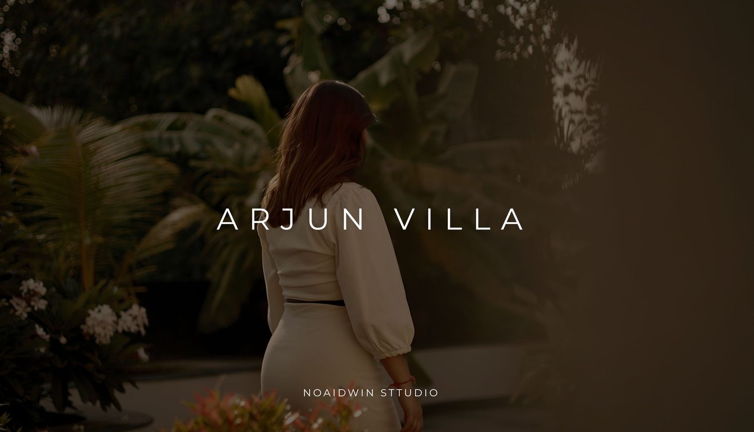 Woman in white dress walking through lush garden at Arjun Villa, photographed by Nordwin Studio.
