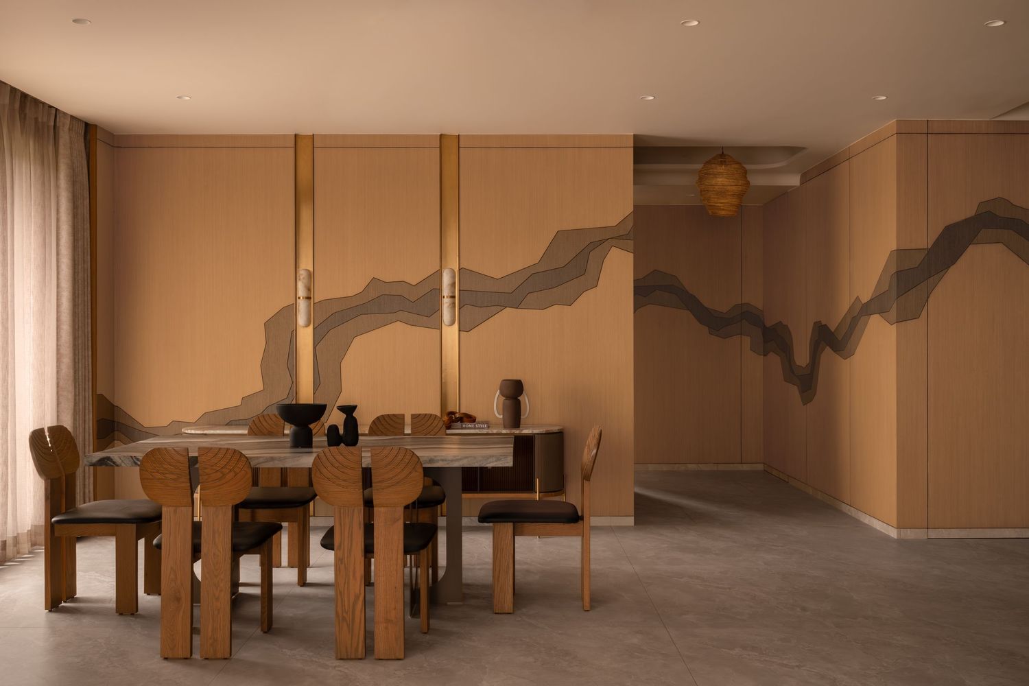 Earthy dining room with abstract wall mural, wooden table and chairs, and warm terracotta tones.