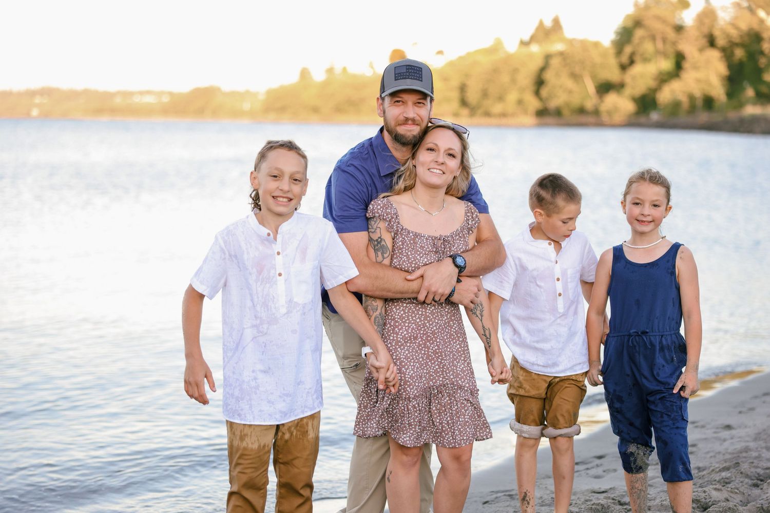 Candid family beach photos with ocean backdrop during sunset.