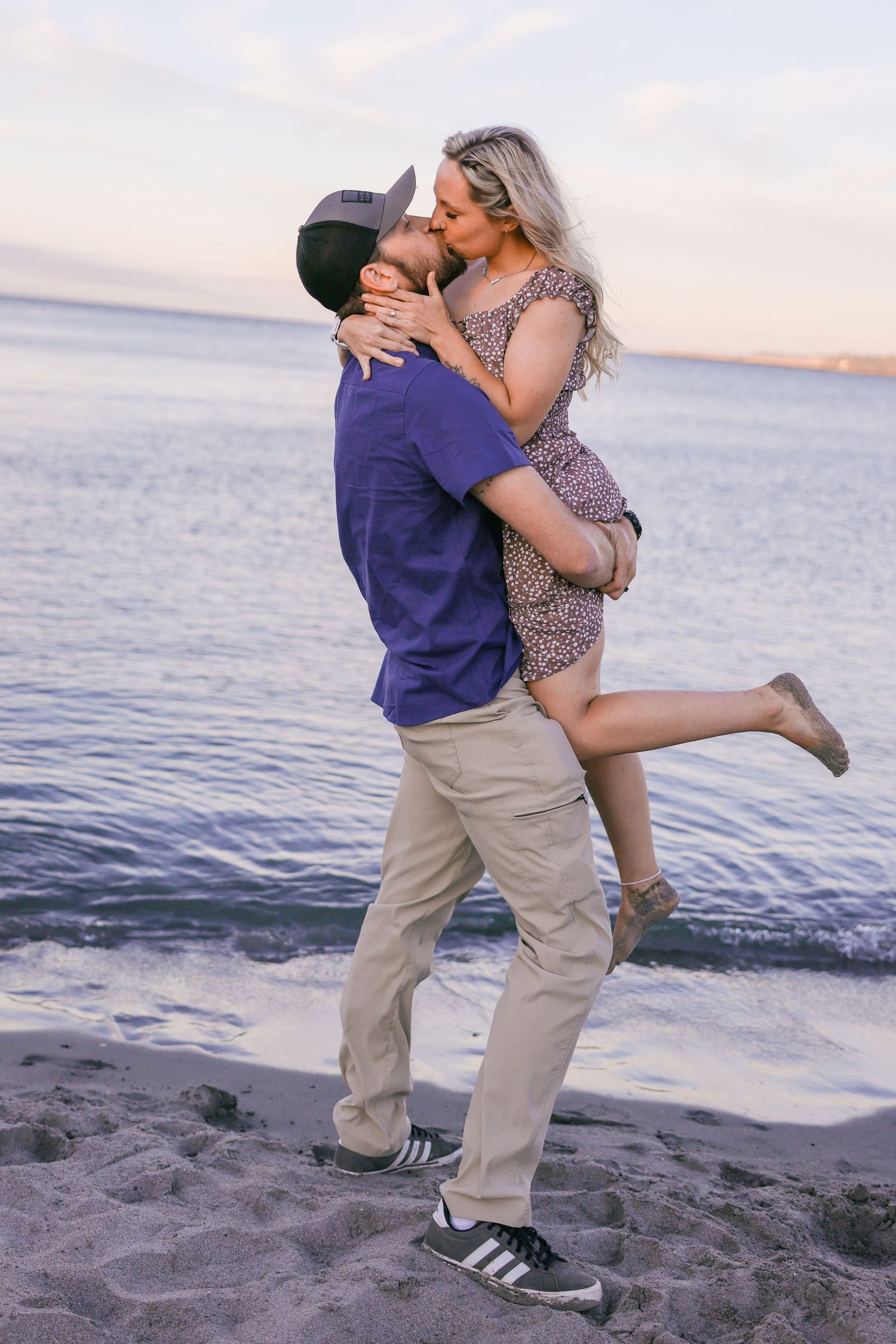 Romantic sunset beach portraits with waves crashing in background.