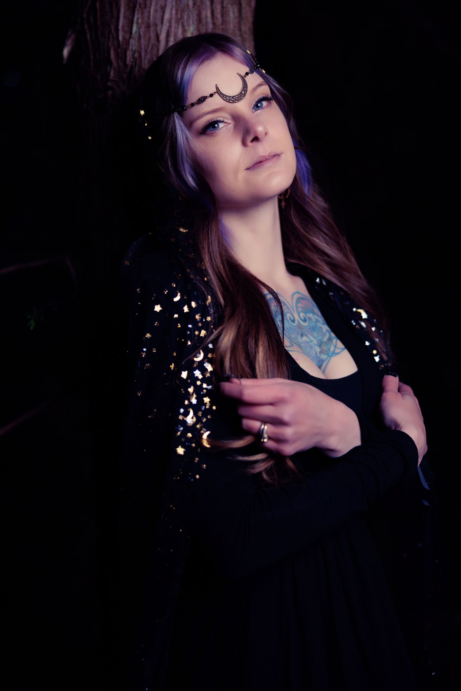 Artistic portrait series in dark lighting with glowing sparkles and blue accents creating a dreamy atmosphere.