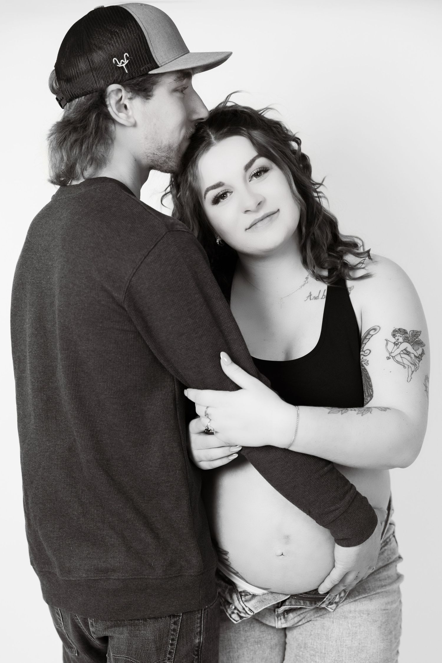 A black and white photo series showing a romantic couple embracing in three intimate poses.