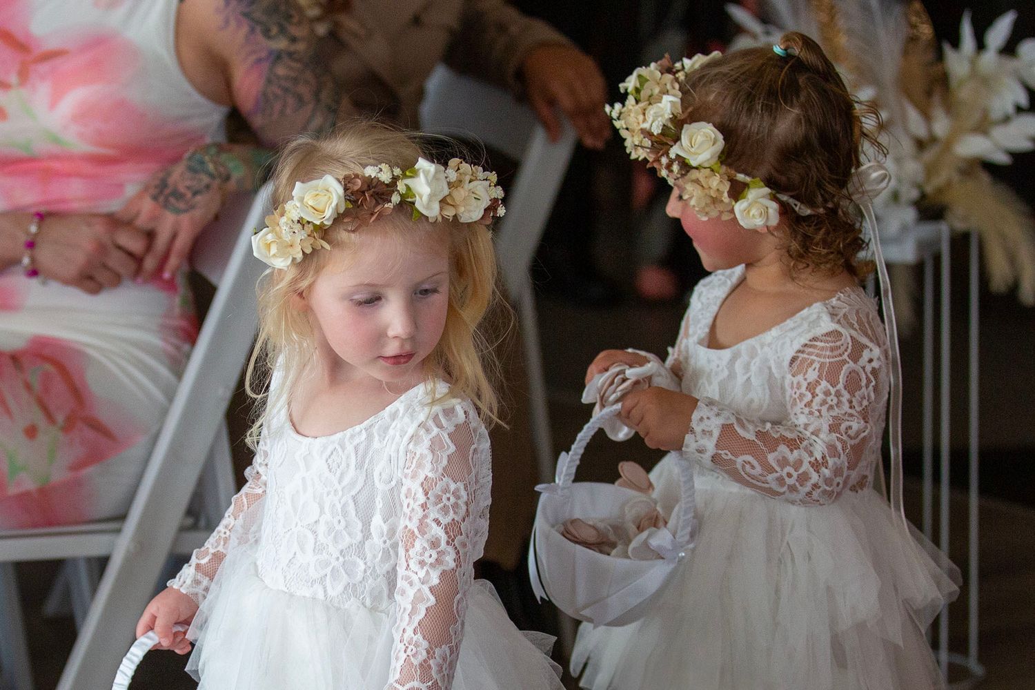 A romantic wedding scene with bridesmaids in elegant pink dresses and floral crowns.