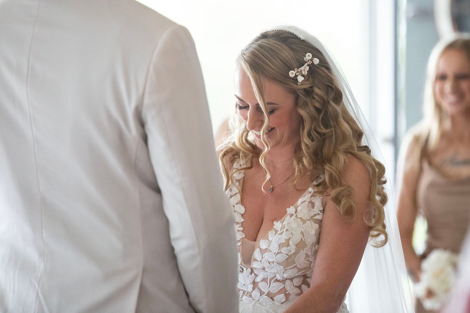 An intimate wedding ceremony moment with delicate white lace details.