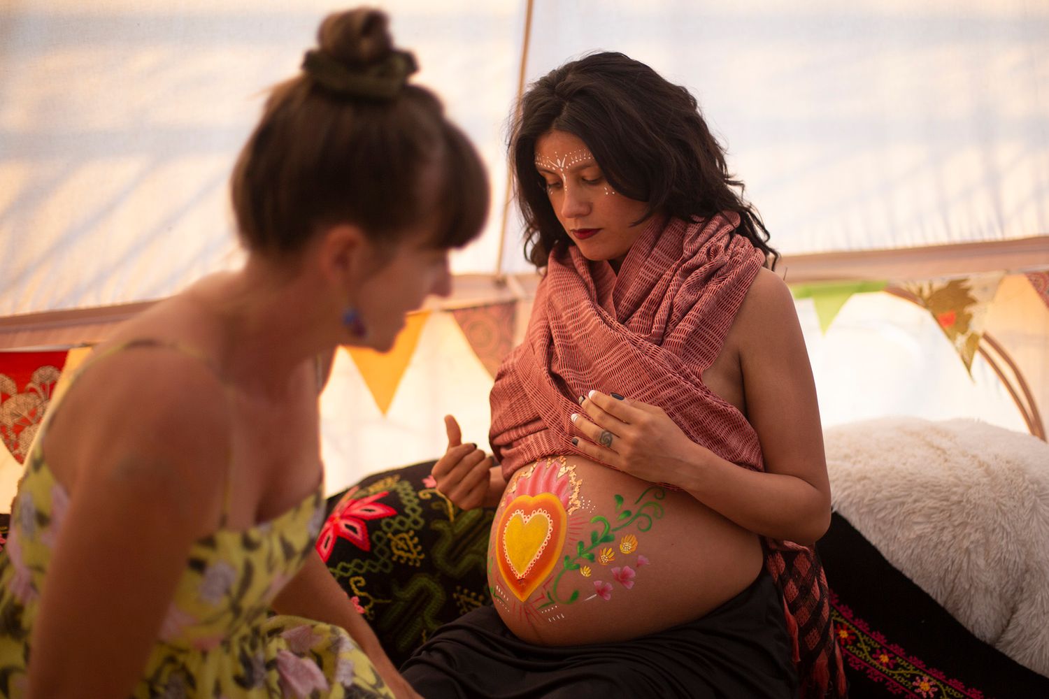 Artistic makeup session being performed in soft natural light.
