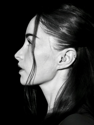 Artistic black and white profile portrait with dramatic lighting.