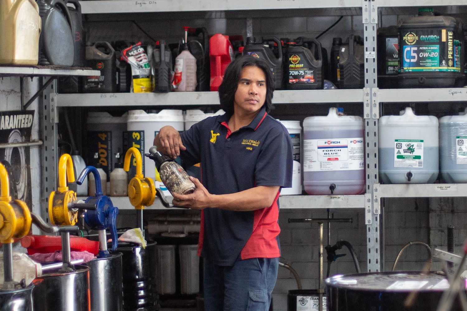 Storage area with organized shelves of automotive supplies and equipment.