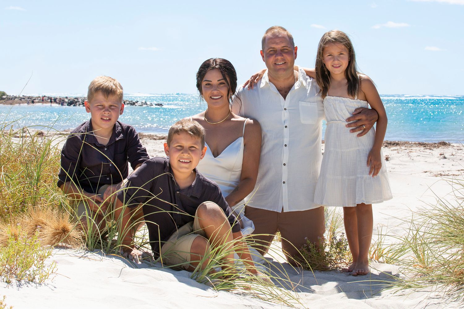 A collection of family beach photos taken on a sunny day showing people posing together on a sandy shoreline.