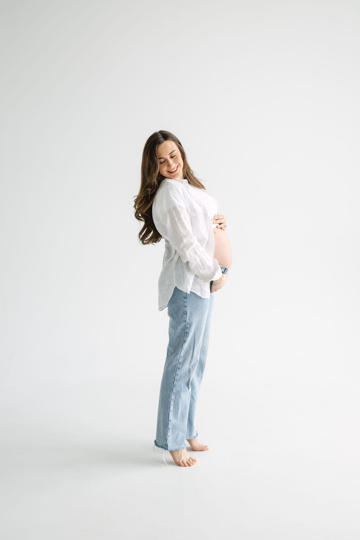 Editorial maternity session at Icon Studio Toronto with clean white backdrop
