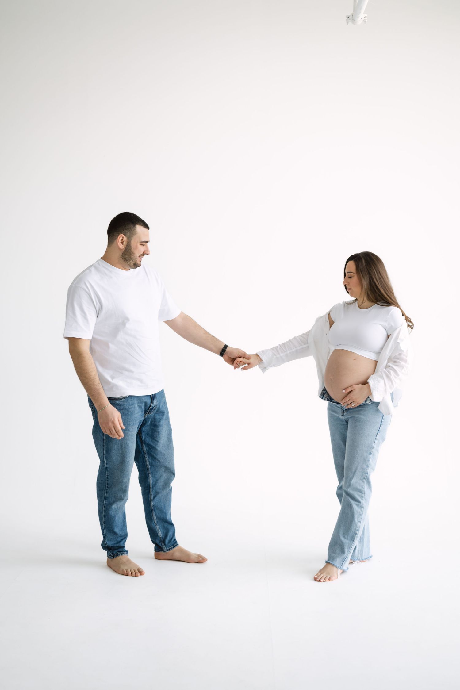 Editorial maternity session at Icon Studio Toronto with clean white backdrop